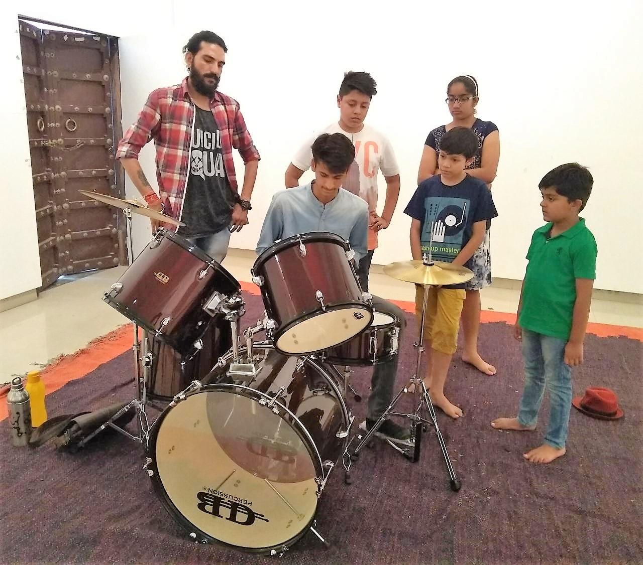 CHILDREN LEARN PERCUSSION INSTRUMENTS AT JUNIOR SUMMER